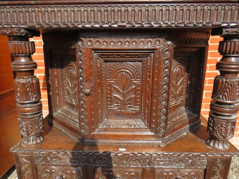 A large part 16th Century carved oak court cupboard with a central cupboard door flanked either - Image 2 of 11