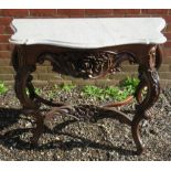 A 19th Century carved mahogany console table with a shaped white marble top.