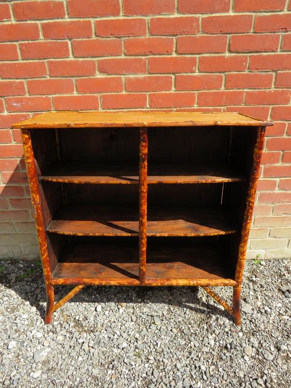 An early 20th Century colonial style bamboo open bookcase with three shelves.