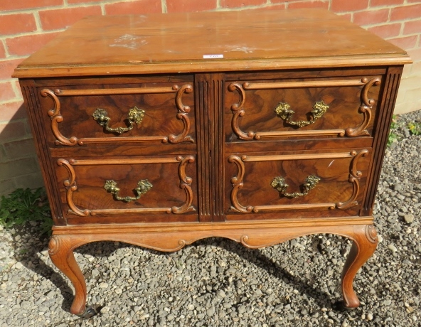 A 19th Century walnut chest of four drawers beneath a quarter veneered top with decorative moulding