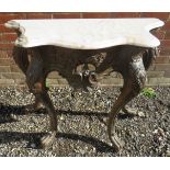 A 19th Century console table with a shaped white marble top over floral carving and a cross