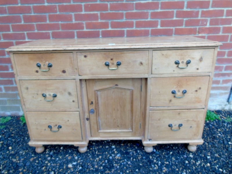 A Victorian pine break front dresser base with central drawer and cupboard,