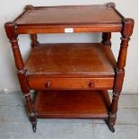 A Victorian mahogany three tier whatnot with a central long drawer and terminating on castors.