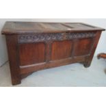 Late 17th/early 18th century panelled oak coffer with a carved frieze.