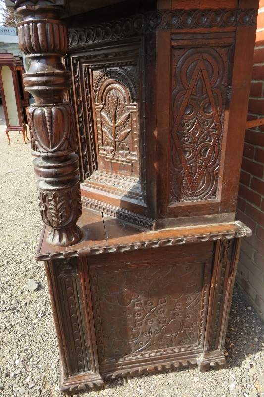 A large part 16th Century carved oak court cupboard with a central cupboard door flanked either - Image 11 of 11