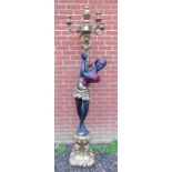 A decorative 20th Century period-style Blackamoore with a four branch candelabra,