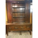 A fine 18th Century country oak high back dresser with a central plate rack to top flanked either