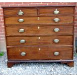 A Georgian mahogany chest of two short over four long graduated drawers with decorative lock