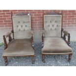 A pair of Victorian carved show wood armchairs re-upholstered in a brown material.