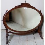 A 19th Century mahogany toilet / vanity mirror with a brass finial to top over an oval swing mirror.