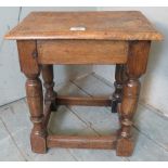 A 19th Century oak joint stool with turned supports and lower stretchers.