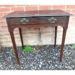 A Georgian oak side table / hall table with a single long frieze drawer and terminating on pad feet.