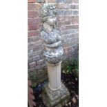 A cast garden bust of a young woman complete with a fluted column base.