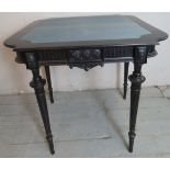 A 19th Century ebonised turn over card table with a blue baize to interior over carving and turned