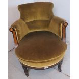 A 19th Century Aesthetic period ebonised and walnut framed tub chair upholstered in a green velvet