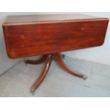 19th century mahogany drop leaf pedestal supper table terminating on claw feet castors.