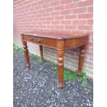 A Victorian mahogany hall / side table with a shaped top over a single drawer.