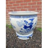 A large decorative blue and white ceramic pot on stand. Condition report: Good overall condition.