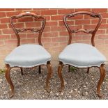 A pretty pair of Victorian walnut framed balloon back occasional chairs with blue upholstered seats.