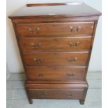 A small Edwardian mahogany combination chest on stand having four graduated drawers to top over a