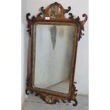 An antique Chippendale-design wall mirror featuring a parcel gilt HoHo bird surmount Condition