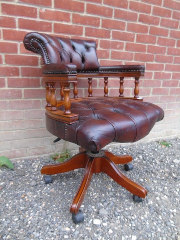 A good quality 20th Century captains swivel and tilting desk chair upholstered in a buttoned