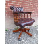 A good quality 20th Century captains swivel and tilting desk chair upholstered in a buttoned