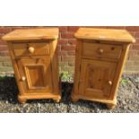 A pair of 20th Century pine bedside cabinets with single drawers over cupboard doors to base.