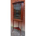 A 19th Century oak corner cupboard on stand with a glazed door revealing internal shelves over an