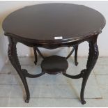 An Edwardian mahogany two tier centre lamp table with fine shaped legs and stretchers.