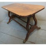 A 20th Century mahogany low side table with lyre end supports and terminating on brass claw feet