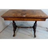 A Victorian burr walnut turn over card table with a burgundy baize over ornate turned legs and