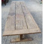 An early rustic three plank refectory dining / kitchen table with a centre lower stretcher bearing