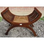 A decorative 19th Century style mahogany framed stool with a caned seat.