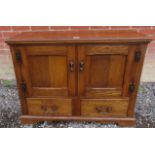 A 20th Century period-style oak cabinet with two cupboard doors over two small drawers to base.