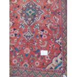 A Hamadan rug on red ground with central