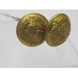 A pair of hat pins made from two brass b
