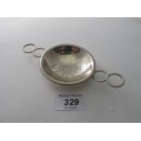 A tea strainer with ring handles, marked