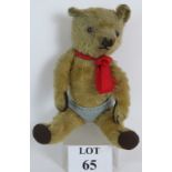 A well loved early 20th Century Mohair Teddy Bear with jointed limbs and glass eyes.