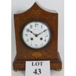 A Victorian inlaid oak cased mantel clock by J W Benson Ltd of London with a striking movement.