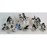 A set of 9 Franklin Mint porcelain penguin figurines by H. Emblem C.1980's. Tallest: 19cm.