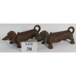A pair of cute cast iron Dachshund sausage dog boot scrapers, 34cm long.