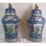 A pair of 20th century large and impressive Chinese porcelain floor vases and domed covers with