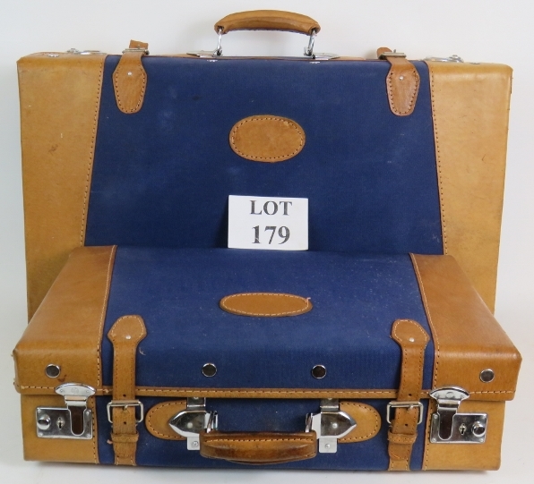 A cool pair of vintage nesting leather bound blue canvas suitcases made by Golden Leaf China.