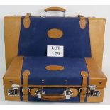 A cool pair of vintage nesting leather bound blue canvas suitcases made by Golden Leaf China.