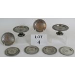 Two small engraved pewter comports and six small dishes, all planished with engraved crests,