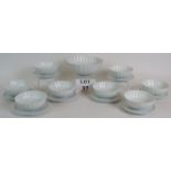 An eight setting Japanese porcelain fruit serving set white of fluted design and marked to base.