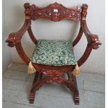 A reproduction period style carved hardwood throne chair, with loose seat cushion.