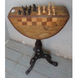A Victorian inlaid mahogany drop leaf pedestal games table, the chess board top above two drawers,