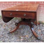 A smart Regency period mahogany drop leaf pedestal supper table with fitted frieze drawer and